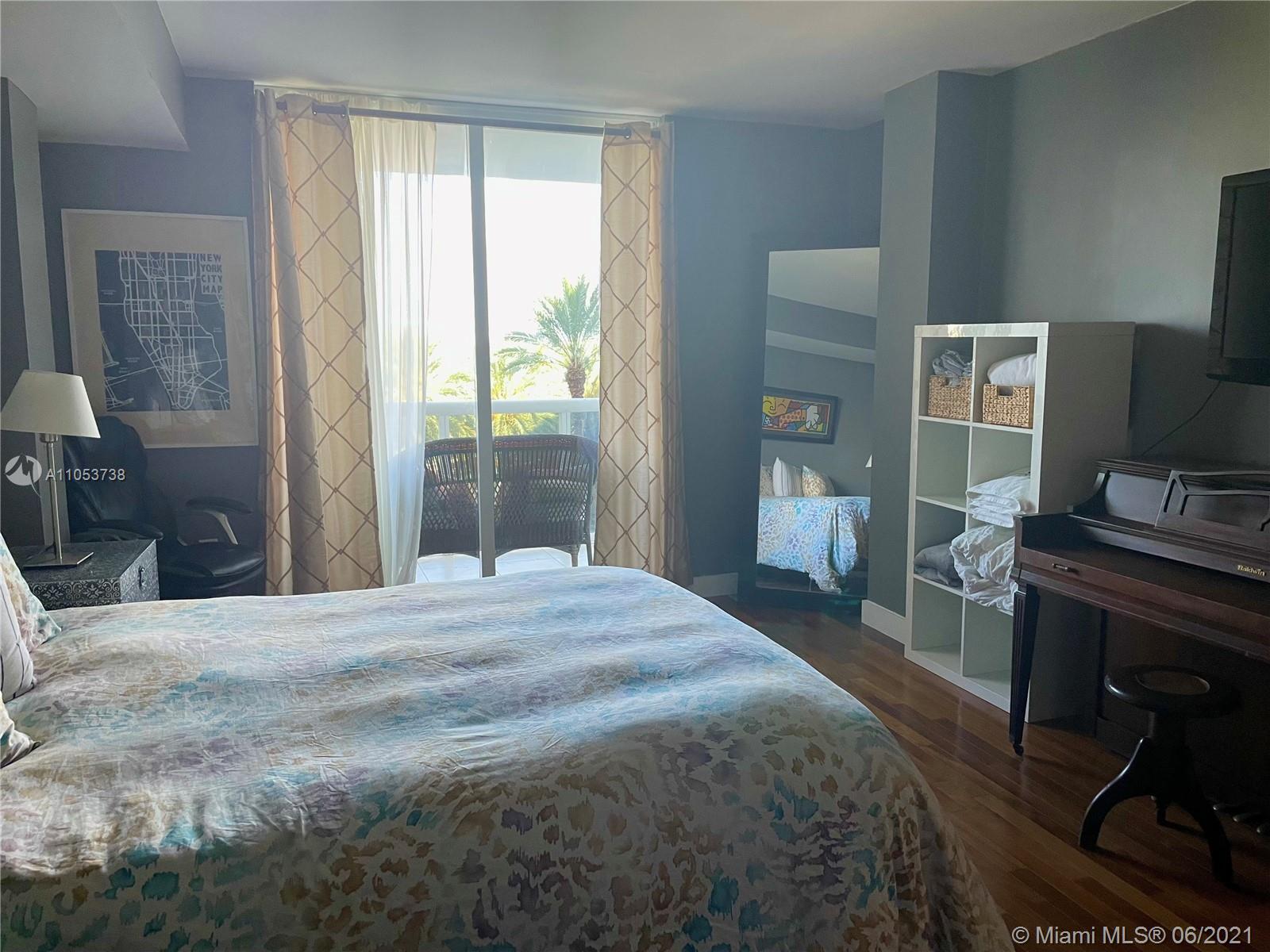 10275 Collins Avenue, Unit 425 Bal Harbour, FL 33154 - Photo 7 of 18 a bedroom with a bed and a flat screen tv
