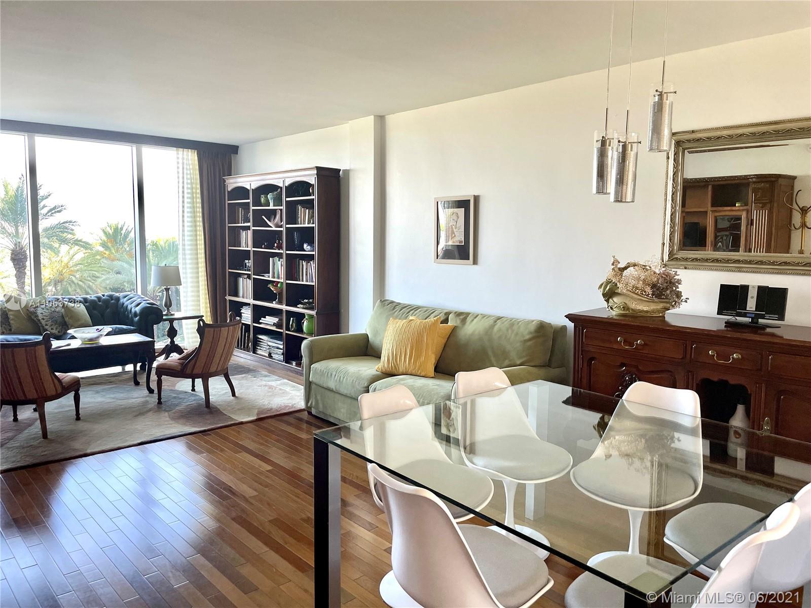 10275 Collins Avenue, Unit 425 Bal Harbour, FL 33154 - Photo 8 of 18 a living room with furniture and a floor to ceiling window