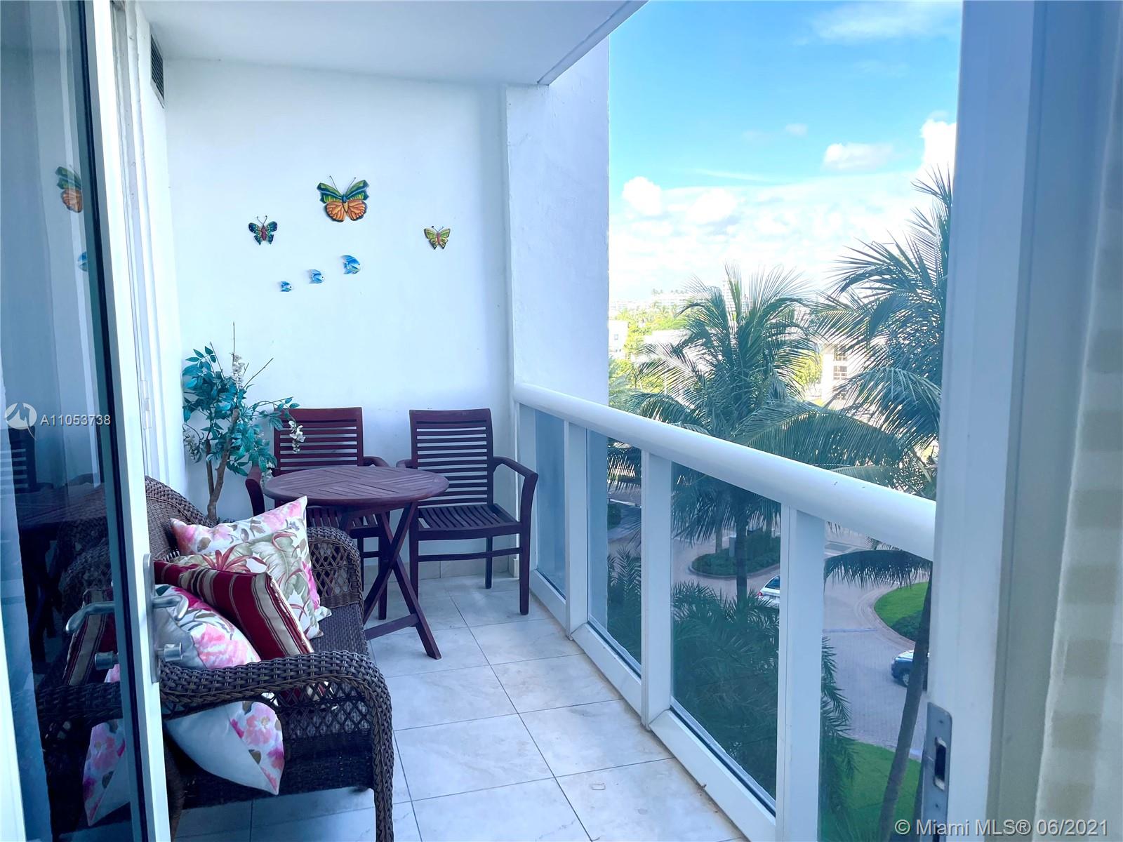 10275 Collins Avenue, Unit 425 Bal Harbour, FL 33154 - Photo 9 of 18 a balcony with table and chairs