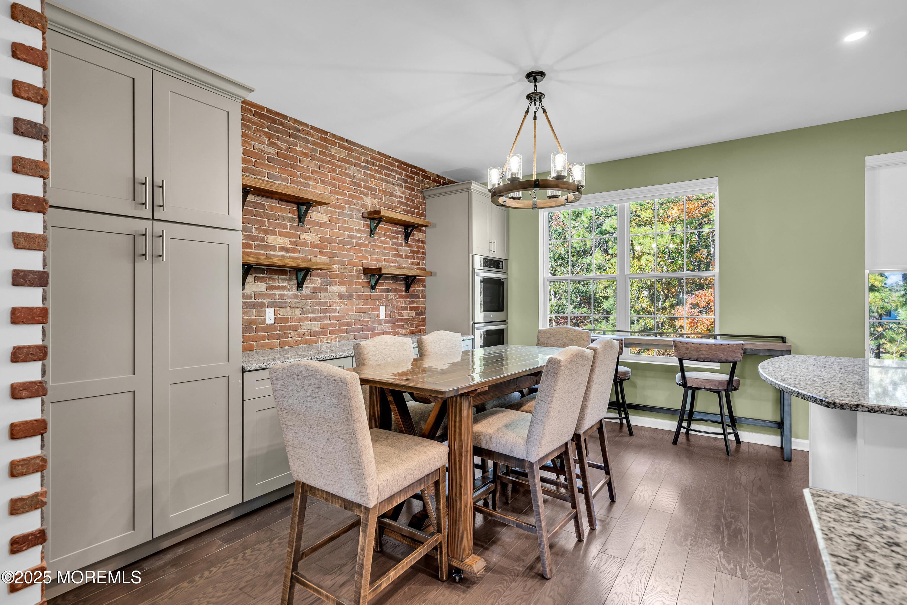 305 Spirit Way, Unit 505 Brick, NJ 08723 - Photo 14 of 28 a dining room with furniture a chandelier and wooden floor