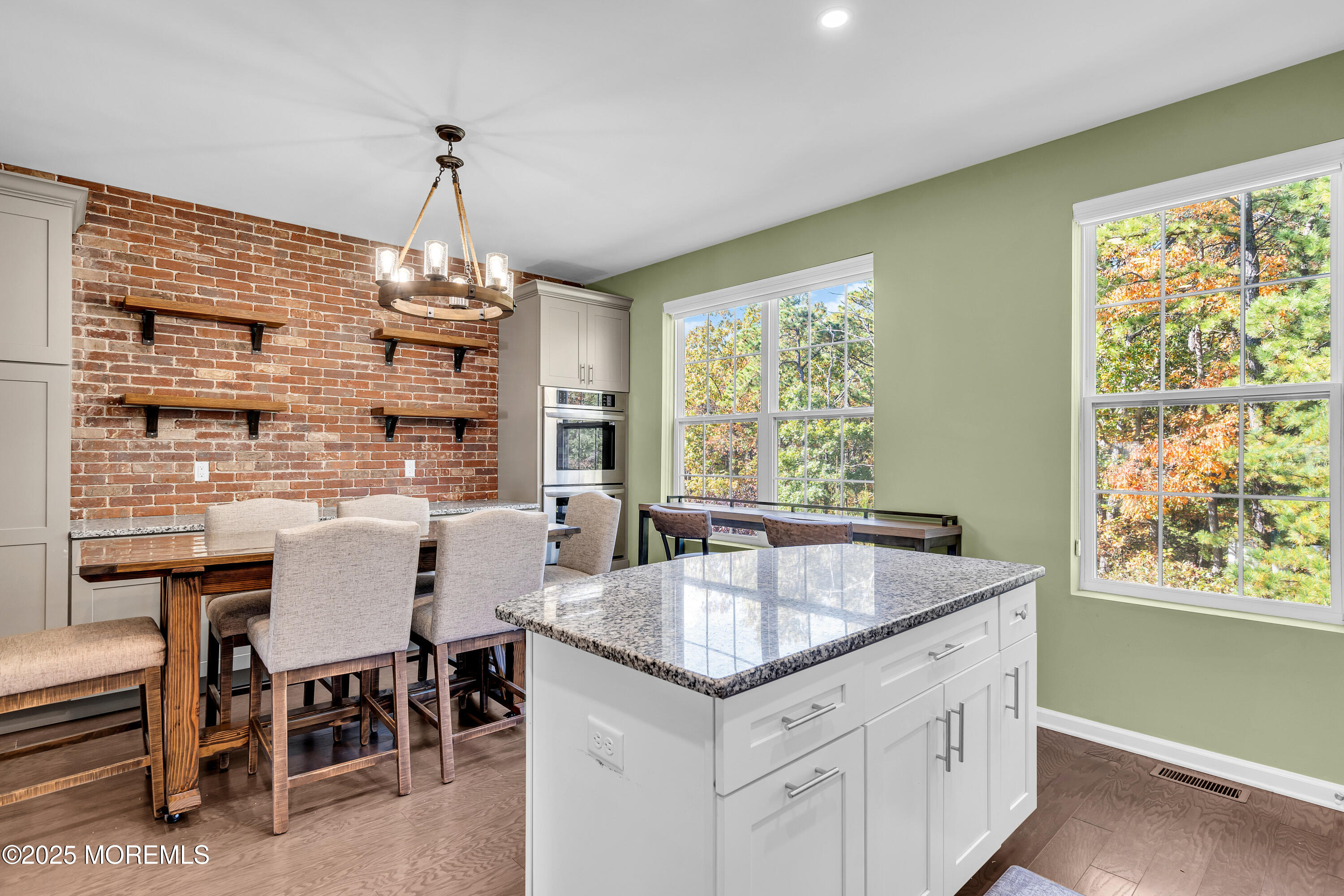 305 Spirit Way, Unit 505 Brick, NJ 08723 - Photo 16 of 28 a kitchen with center island table and chairs