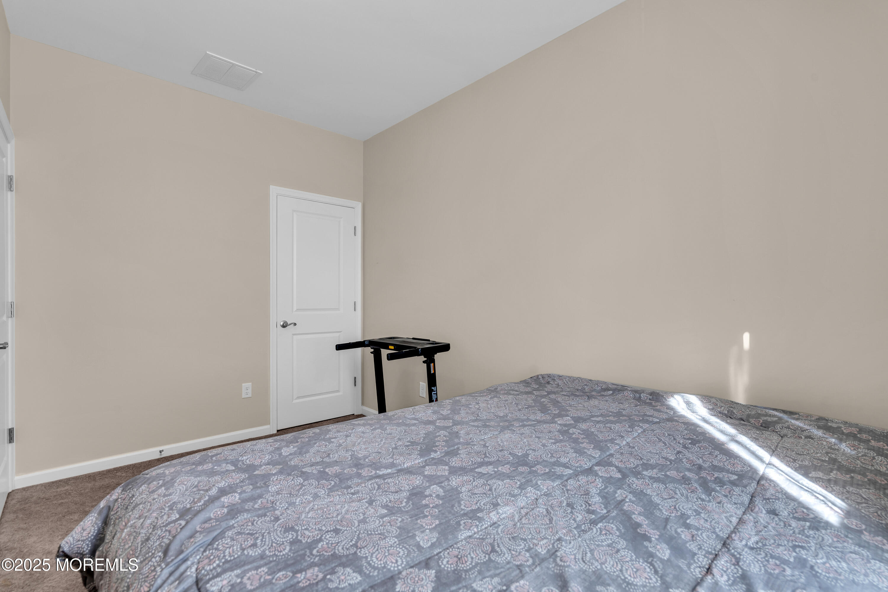 305 Spirit Way, Unit 505 Brick, NJ 08723 - Photo 22 of 28 a bedroom with a bed and a table