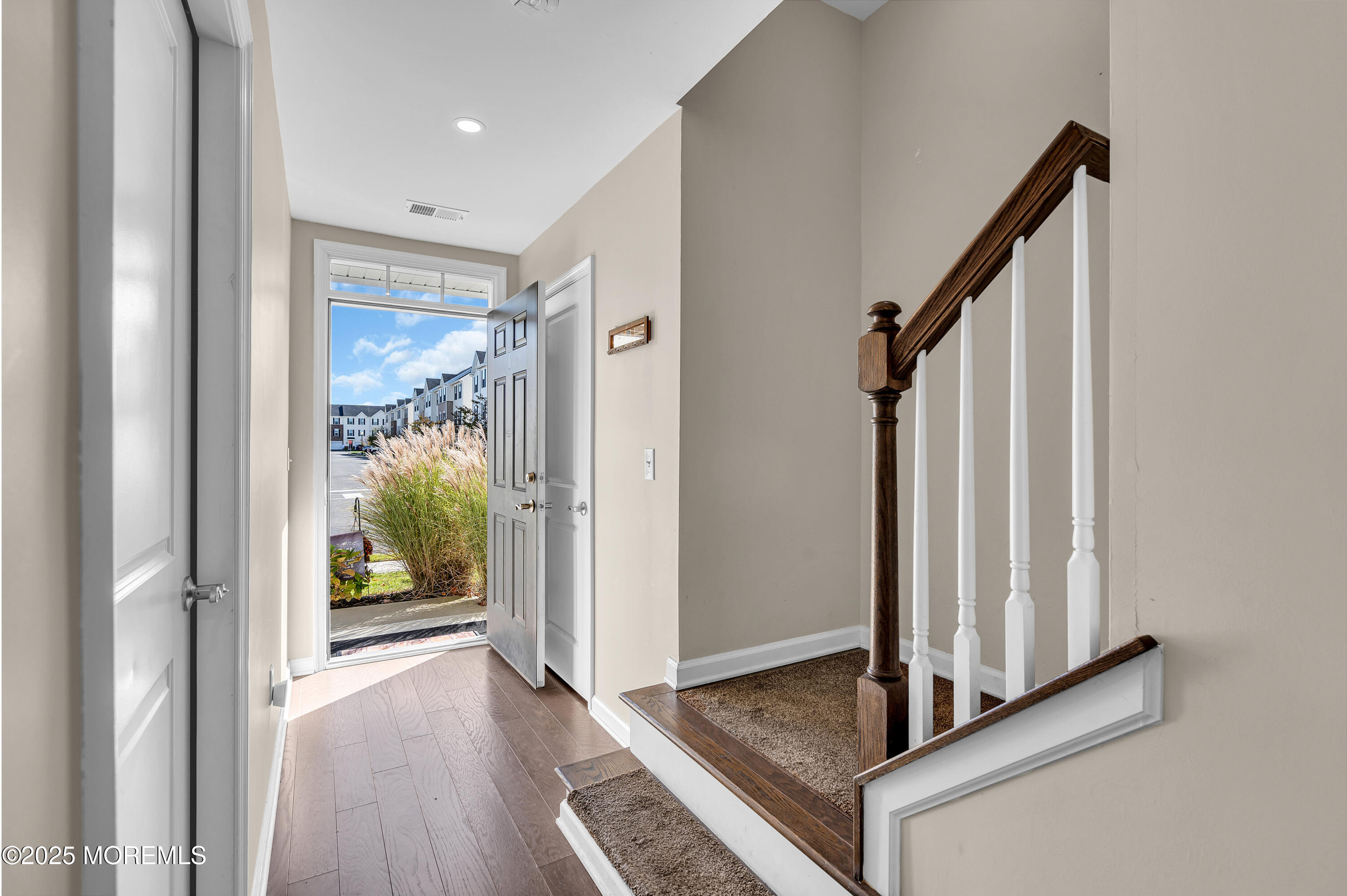 305 Spirit Way, Unit 505 Brick, NJ 08723 - Photo 3 of 28 a view of a hallway with wooden floor and staircase
