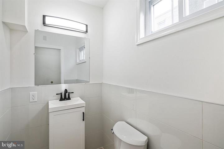 921 South Alden Street Philadelphia, PA 19143 - Photo 12 of 28 a bathroom with a sink a toilet and mirror