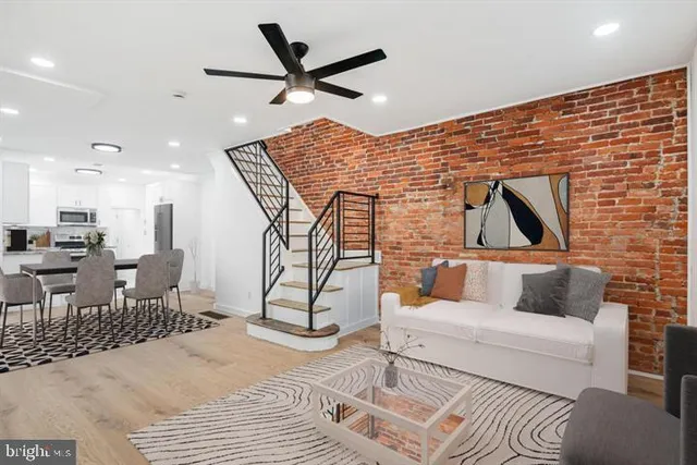 an empty room with wooden floor and entryway
