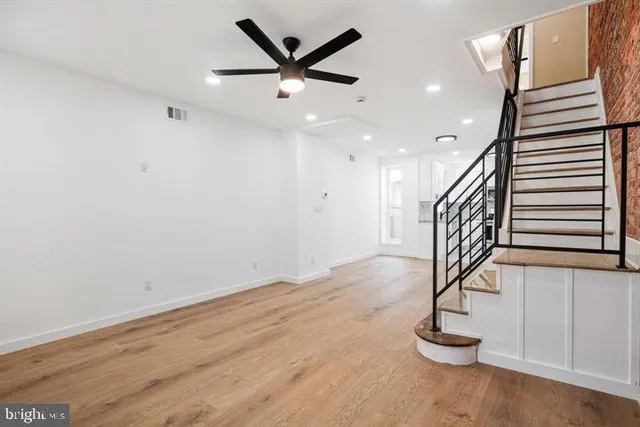 a kitchen with granite countertop white cabinets and stainless steel appliances