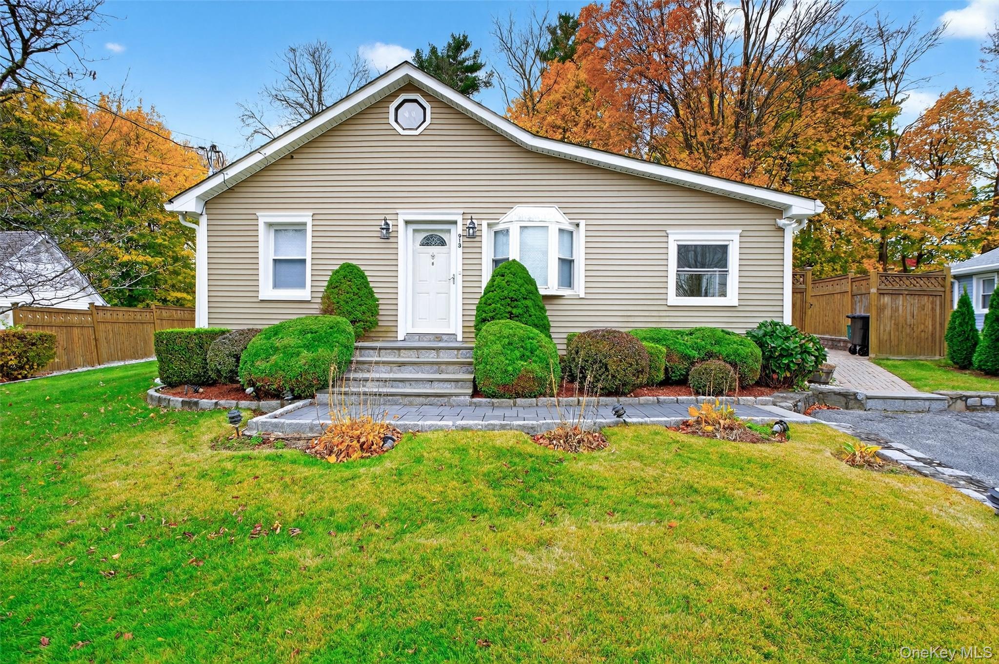 a front view of house with yard and green space
