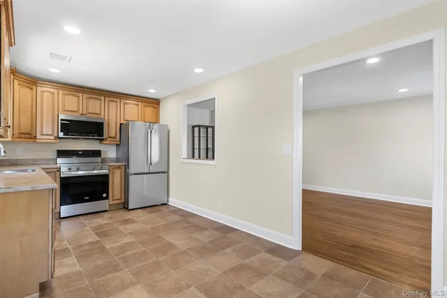 a kitchen with stainless steel appliances a refrigerator and a stove top oven