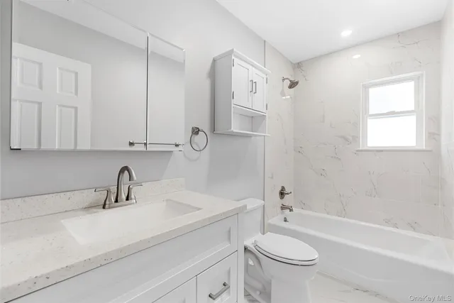 a bathroom with a sink a toilet and a bathtub