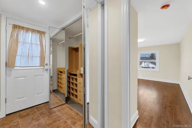 an entryway of a house and an empty room