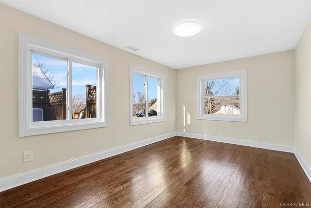 a view of a room with wooden floor and window
