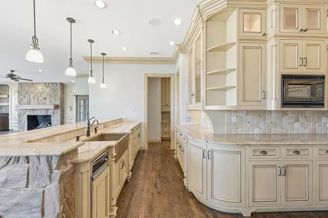 a kitchen with granite countertop white cabinets and sink