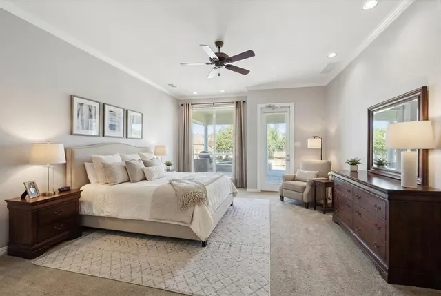 an empty room with ceiling fan and windows