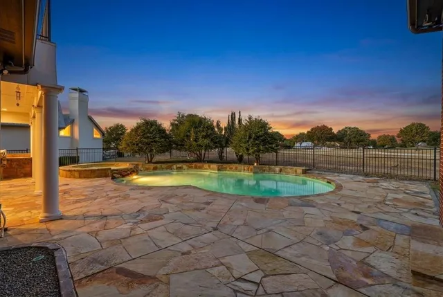 a living room with fireplace furniture and a large window