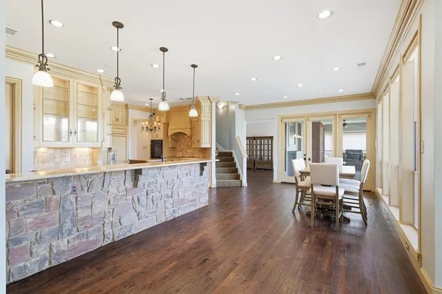 a kitchen with cabinets and wooden floor
