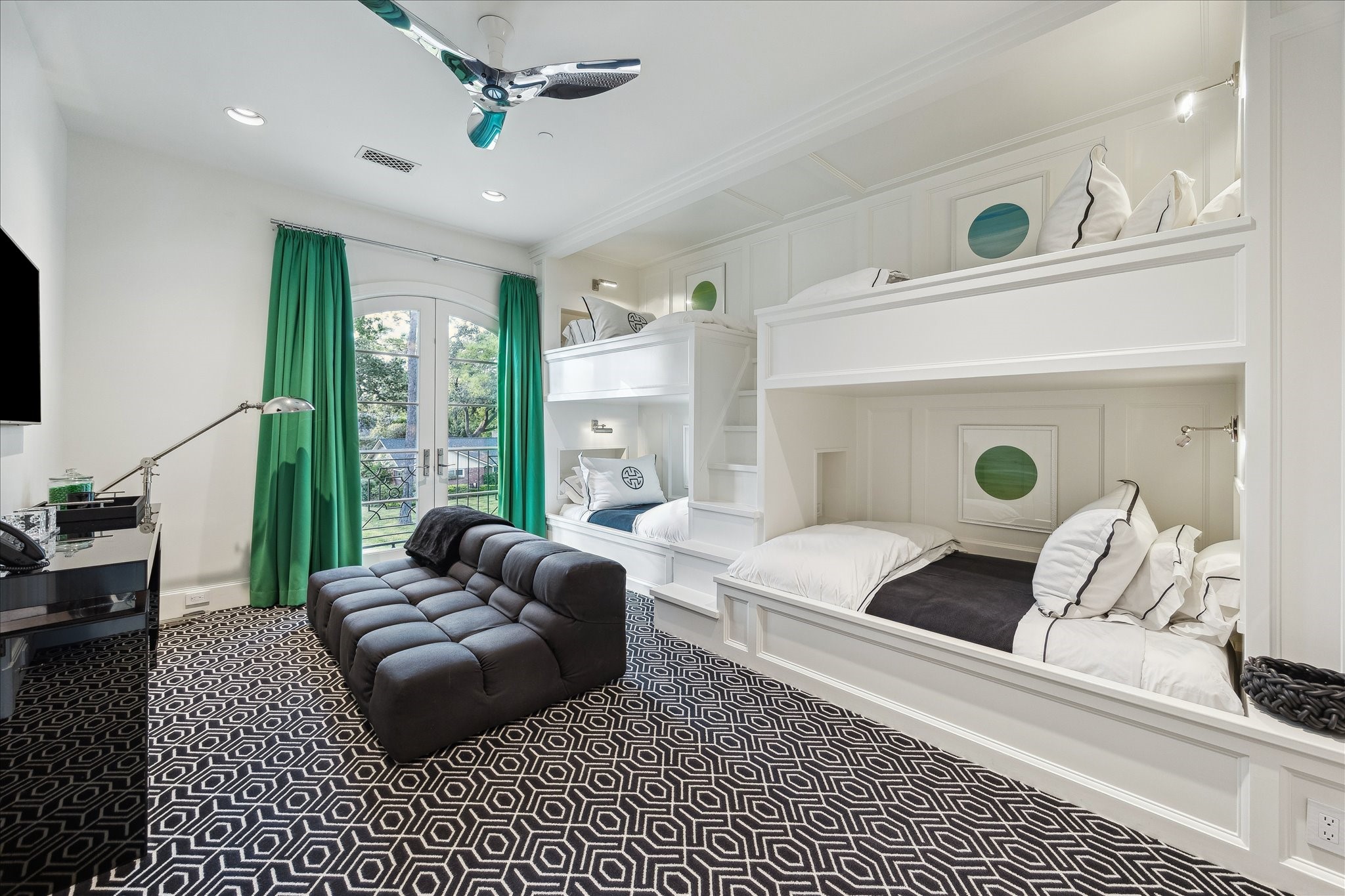 220 Merrie Way Lane Houston, TX 77024 - Photo 38 of 50 A charming bunk room featuring four built-in beds with reading lights and cubbies, plush carpeting, French doors to a Juliet balcony, and Segreto-finished walls and ceiling.