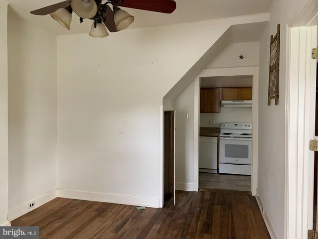 a view of a hallway with wooden floor and closet