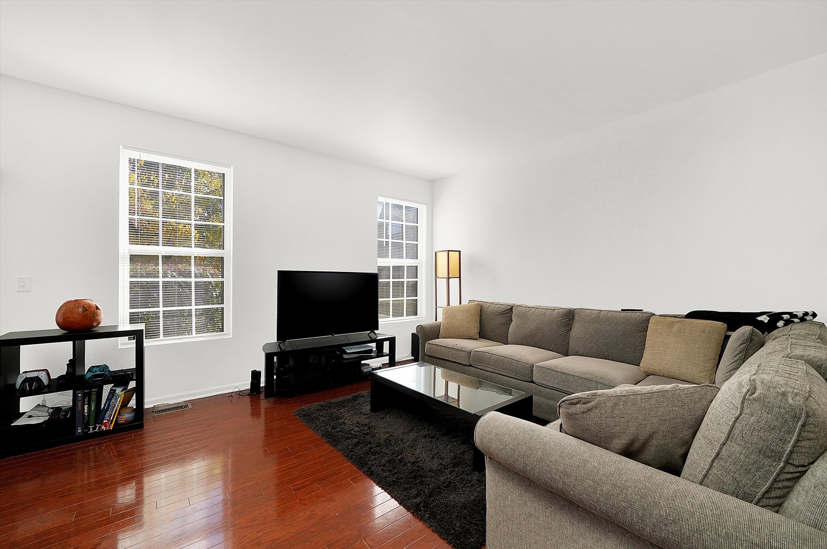 1956 West Cobblestone Road Romeoville, IL 60446 - Photo 5 of 14 a living room with furniture and a flat screen tv