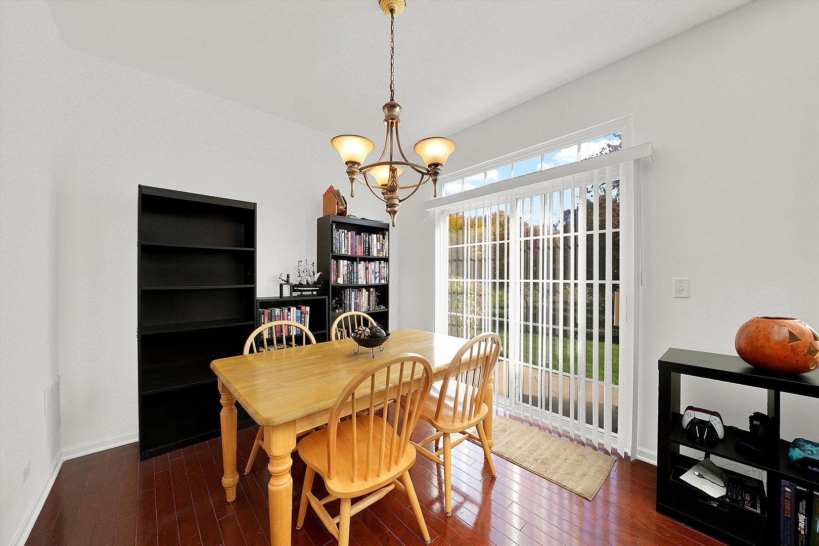 1956 West Cobblestone Road Romeoville, IL 60446 - Photo 6 of 14 a view of a dining room with furniture wooden floor and chandelier