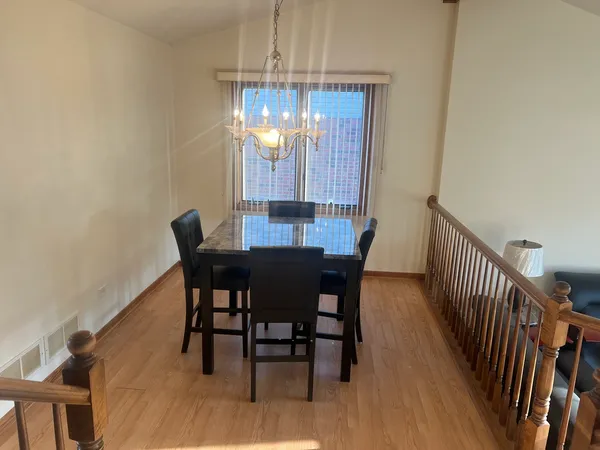 a view of a dining room with furniture and chandelier