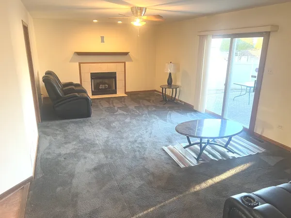 a living room with furniture a fireplace and a table