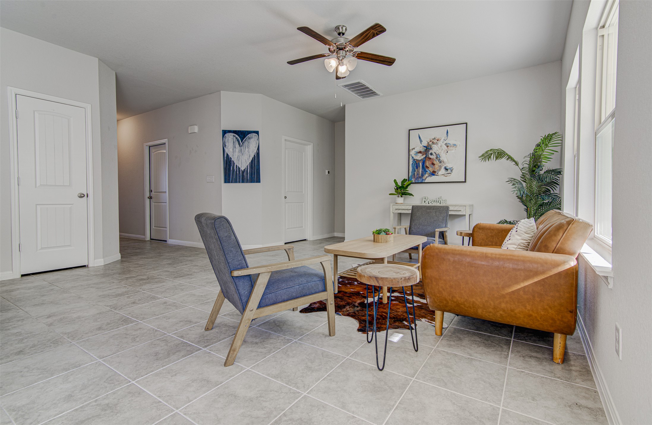 316 Pepper Mill Loop Burnet, TX 78611 - Photo 5 of 27 Sun-filled living area featuring elegant tile flooring and a refreshing ceiling fan.