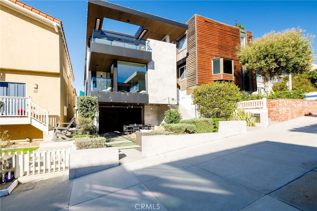 a view of a house with a patio and a yard
