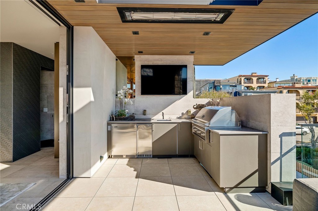 121 25th Street Manhattan Beach, CA 90266 - Photo 13 of 75 a kitchen with stainless steel appliances granite countertop a stove and a refrigerator