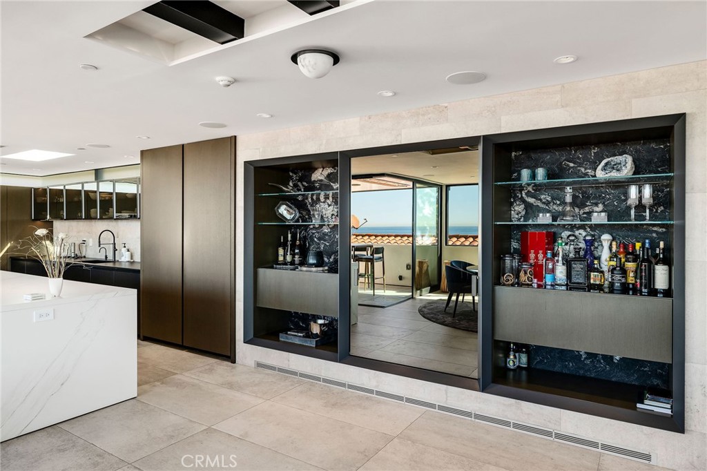 121 25th Street Manhattan Beach, CA 90266 - Photo 24 of 75 a kitchen with stainless steel appliances kitchen island granite countertop a refrigerator and a sink