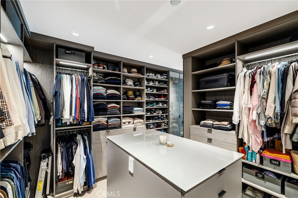 121 25th Street Manhattan Beach, CA 90266 - Photo 41 of 75 a view of walk in closet with clothes and shoes