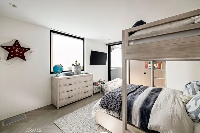 a spacious bedroom with a bed and a window