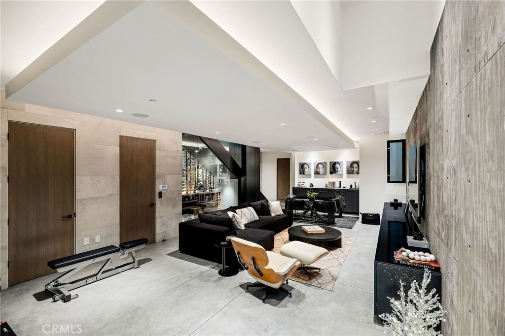 121 25th Street Manhattan Beach, CA 90266 - Photo 68 of 75 a living room with furniture gym equipment and a large window