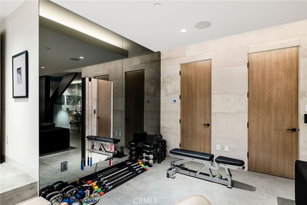 121 25th Street Manhattan Beach, CA 90266 - Photo 72 of 75 a room with gym equipment and large mirror