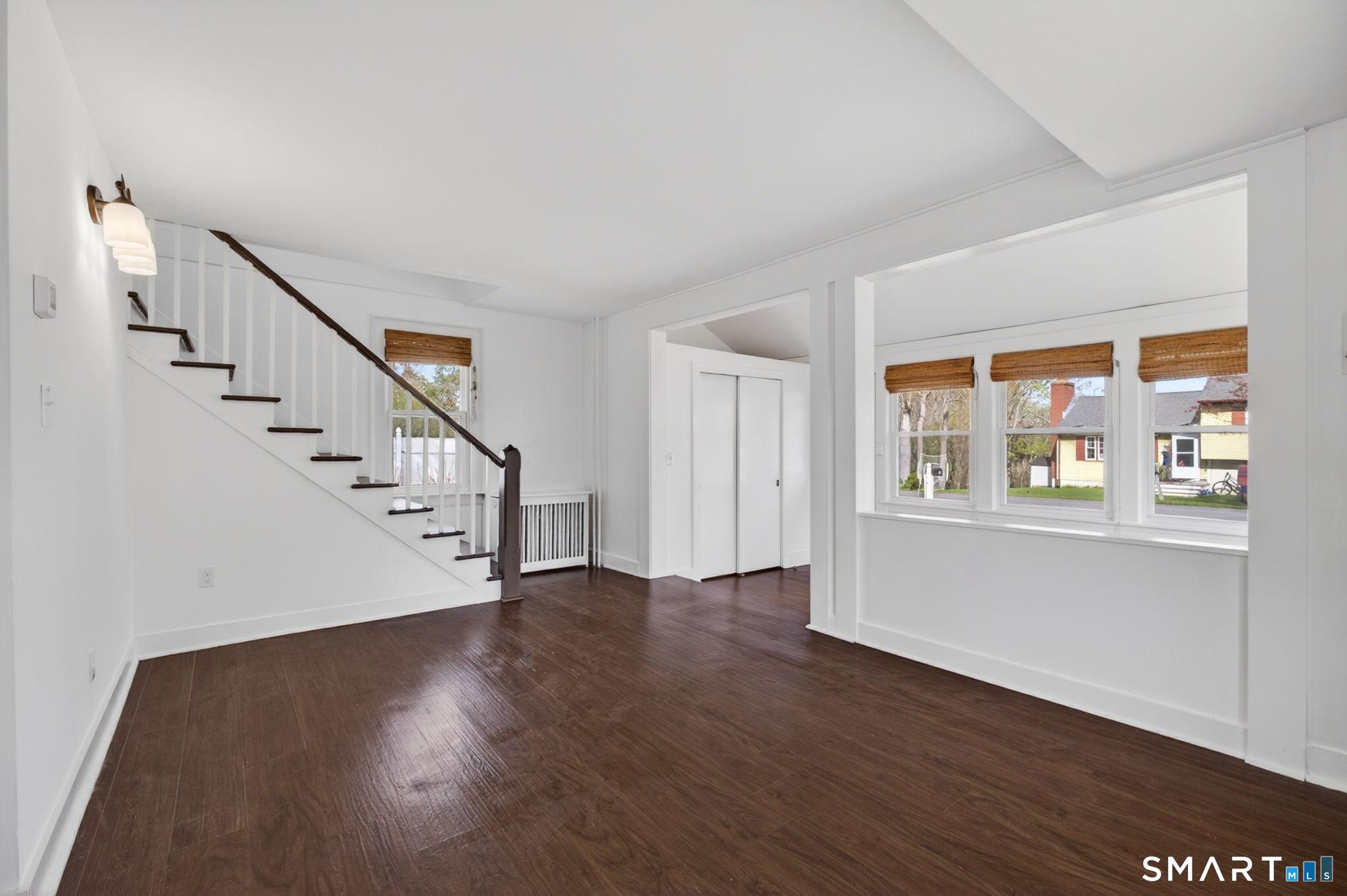 61 Ingham Hill Road Old Saybrook, CT 06475 - Photo 14 of 32 a view of an empty room with wooden floor and a window