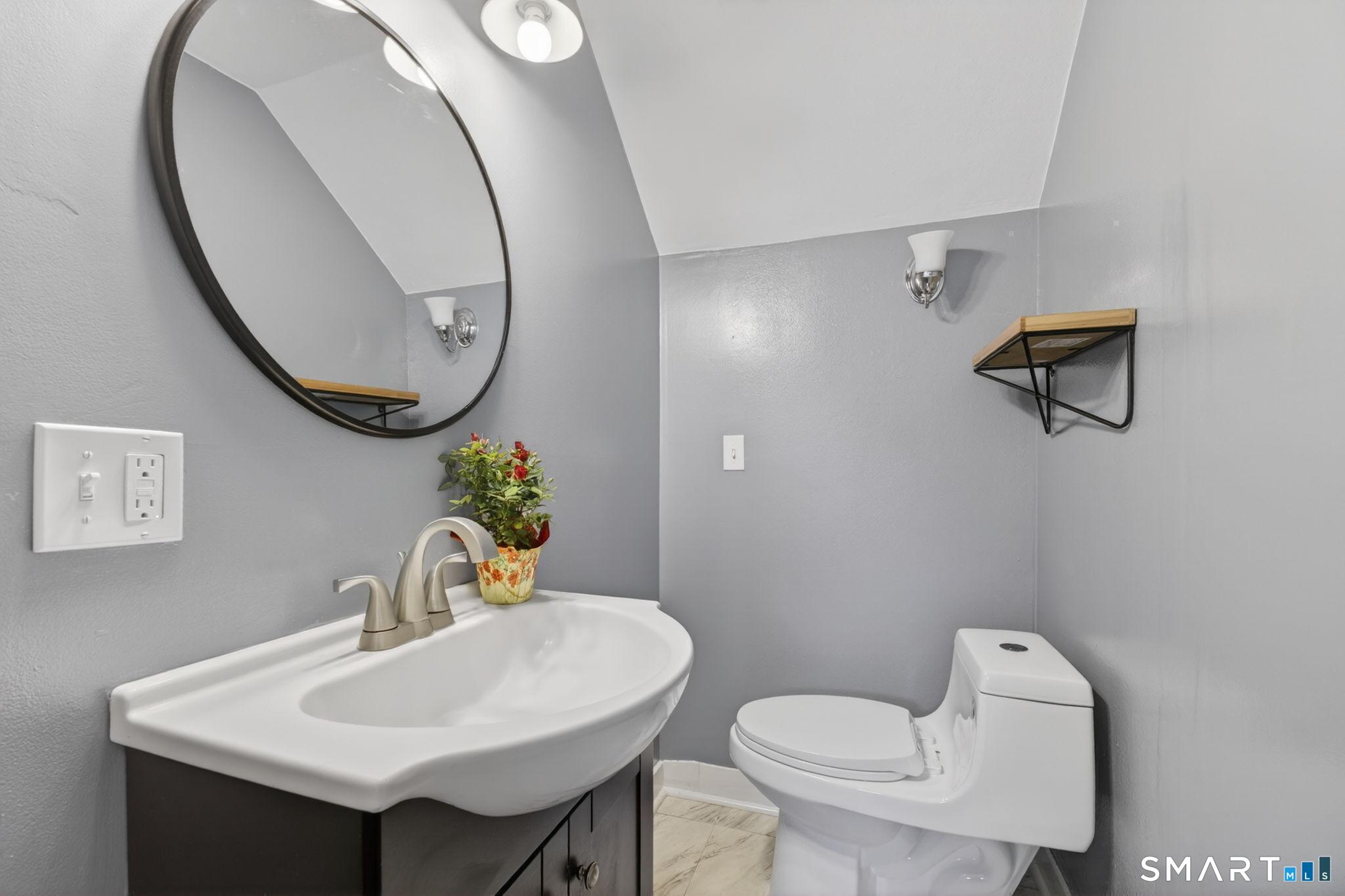 61 Ingham Hill Road Old Saybrook, CT 06475 - Photo 16 of 32 a bathroom with a toilet a sink and a mirror