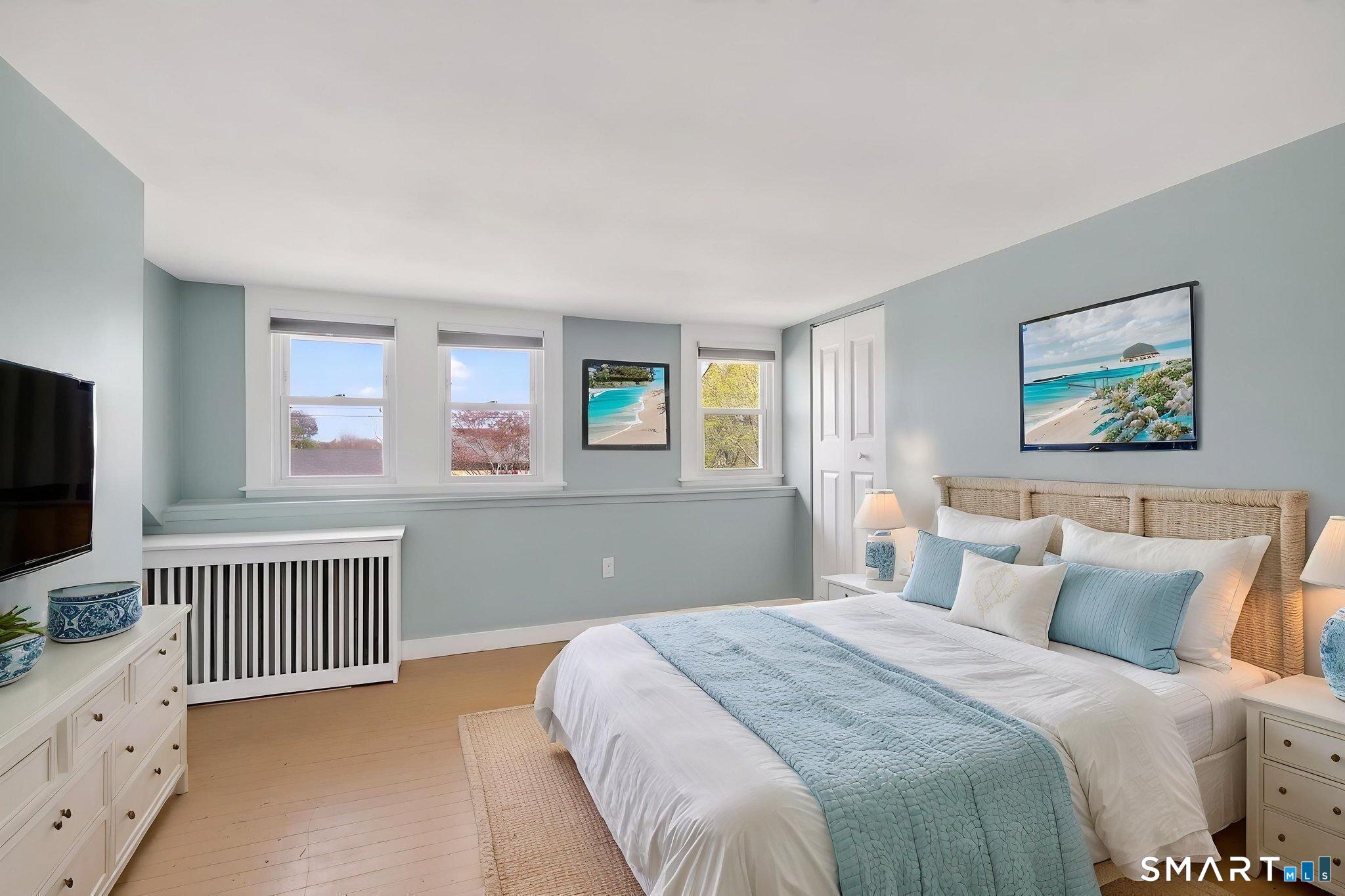 61 Ingham Hill Road Old Saybrook, CT 06475 - Photo 17 of 32 a bedroom with a bed and a flat screen tv