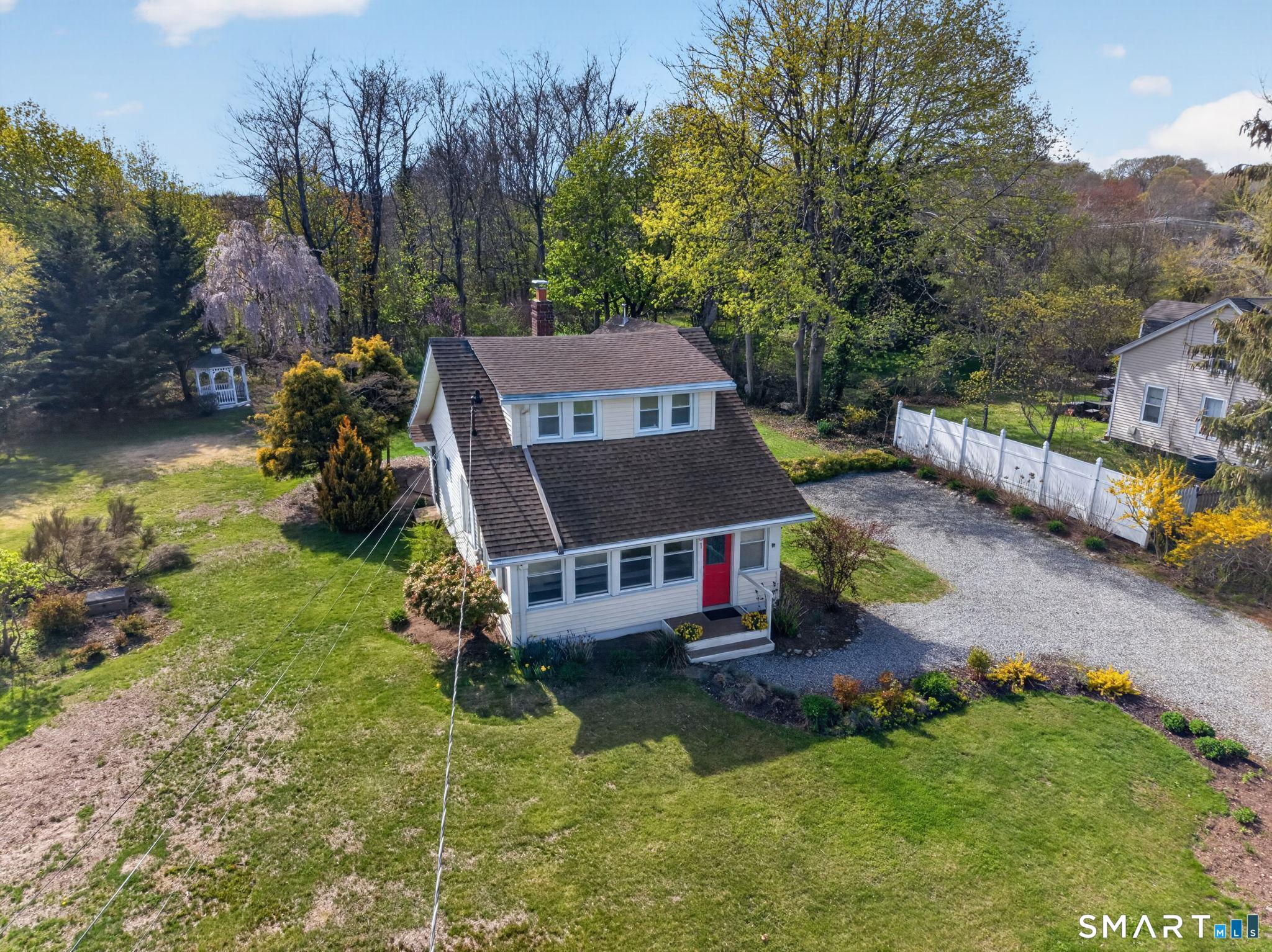 61 Ingham Hill Road Old Saybrook, CT 06475 - Photo 2 of 32 a aerial view of a house with swimming pool next to a yard