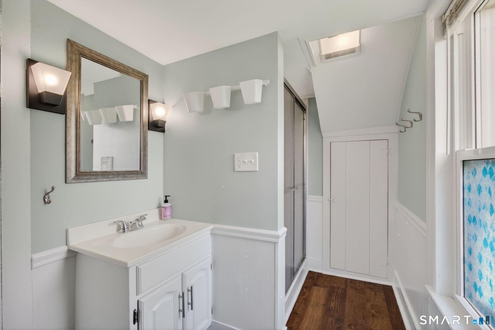 61 Ingham Hill Road Old Saybrook, CT 06475 - Photo 21 of 32 a bathroom with a sink and a mirror