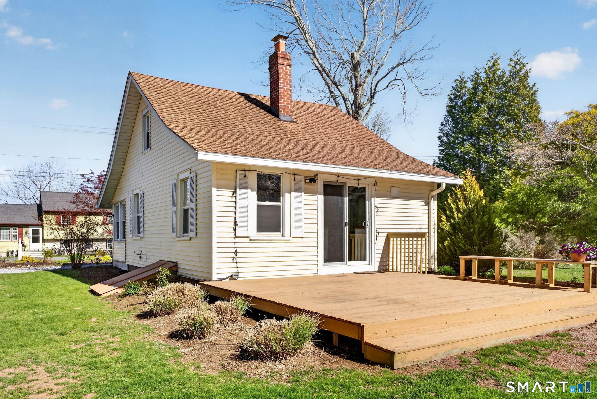 61 Ingham Hill Road Old Saybrook, CT 06475 - Photo 24 of 32 a front view of a house with a yard