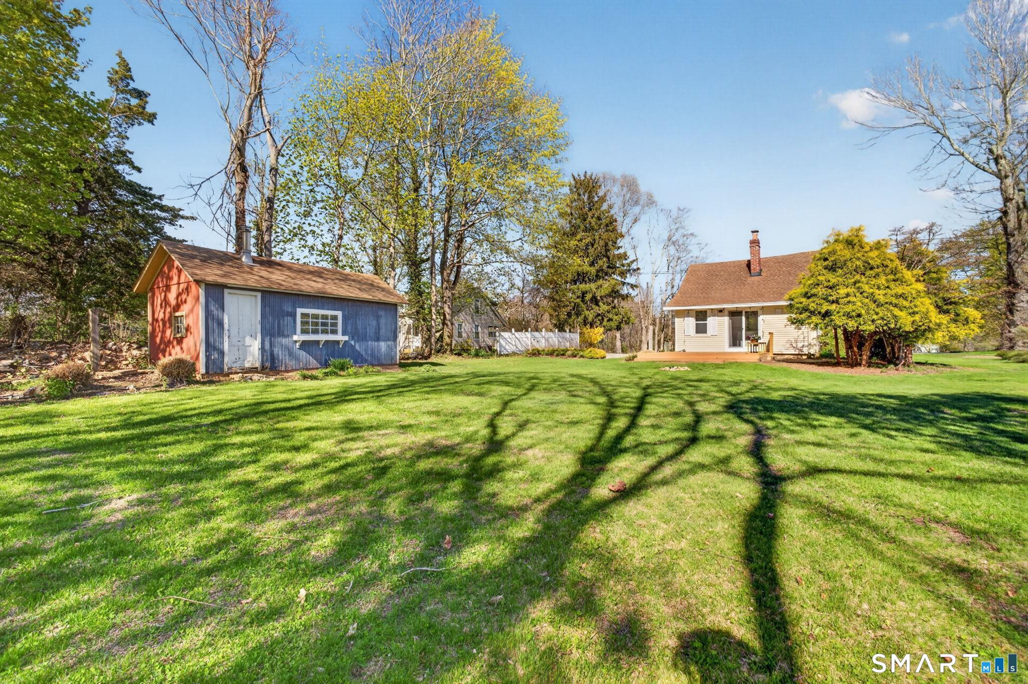 61 Ingham Hill Road Old Saybrook, CT 06475 - Photo 26 of 32 a view of an house with backyard and trees