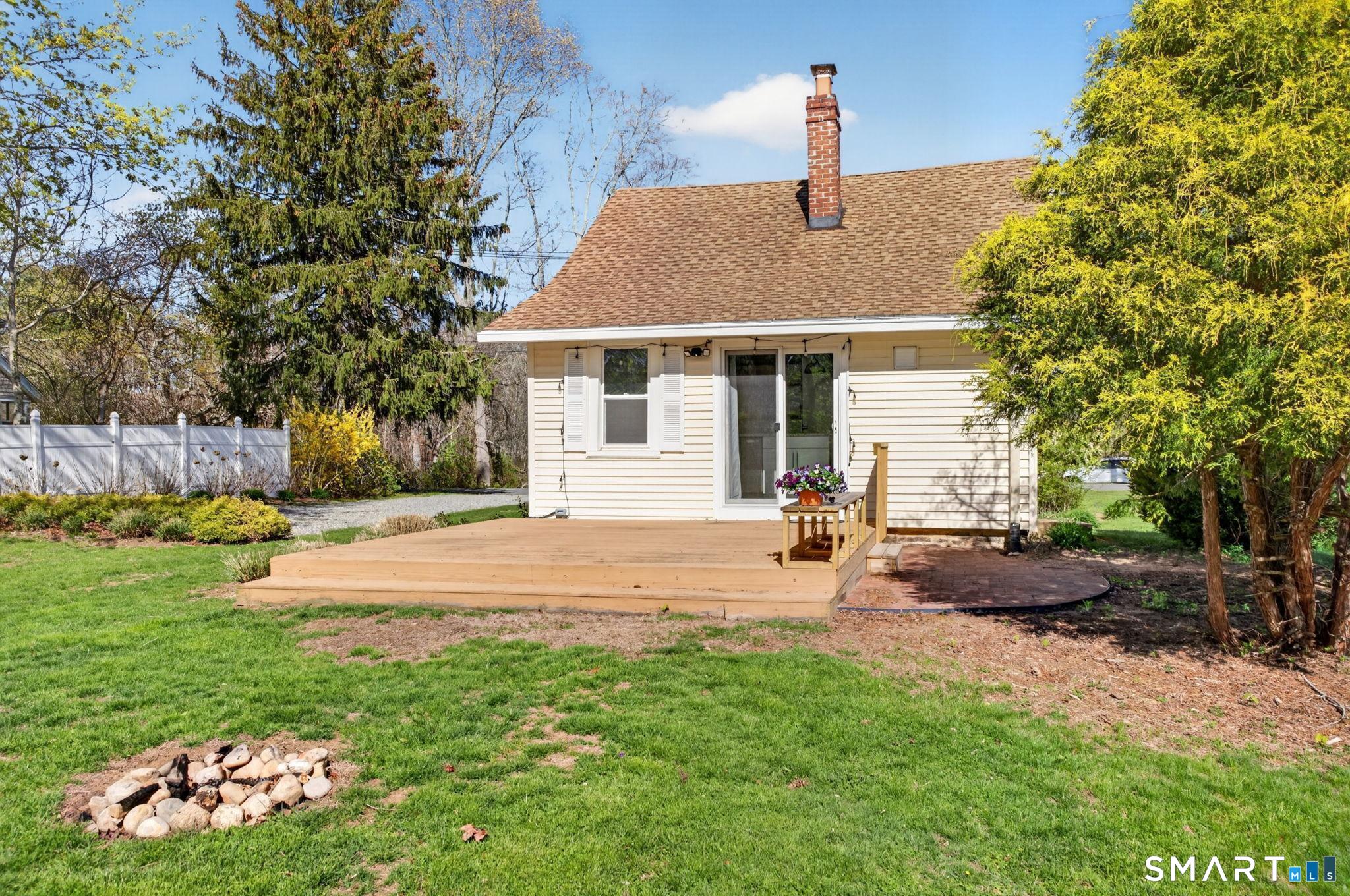 61 Ingham Hill Road Old Saybrook, CT 06475 - Photo 28 of 32 a view of a house with backyard and sitting area