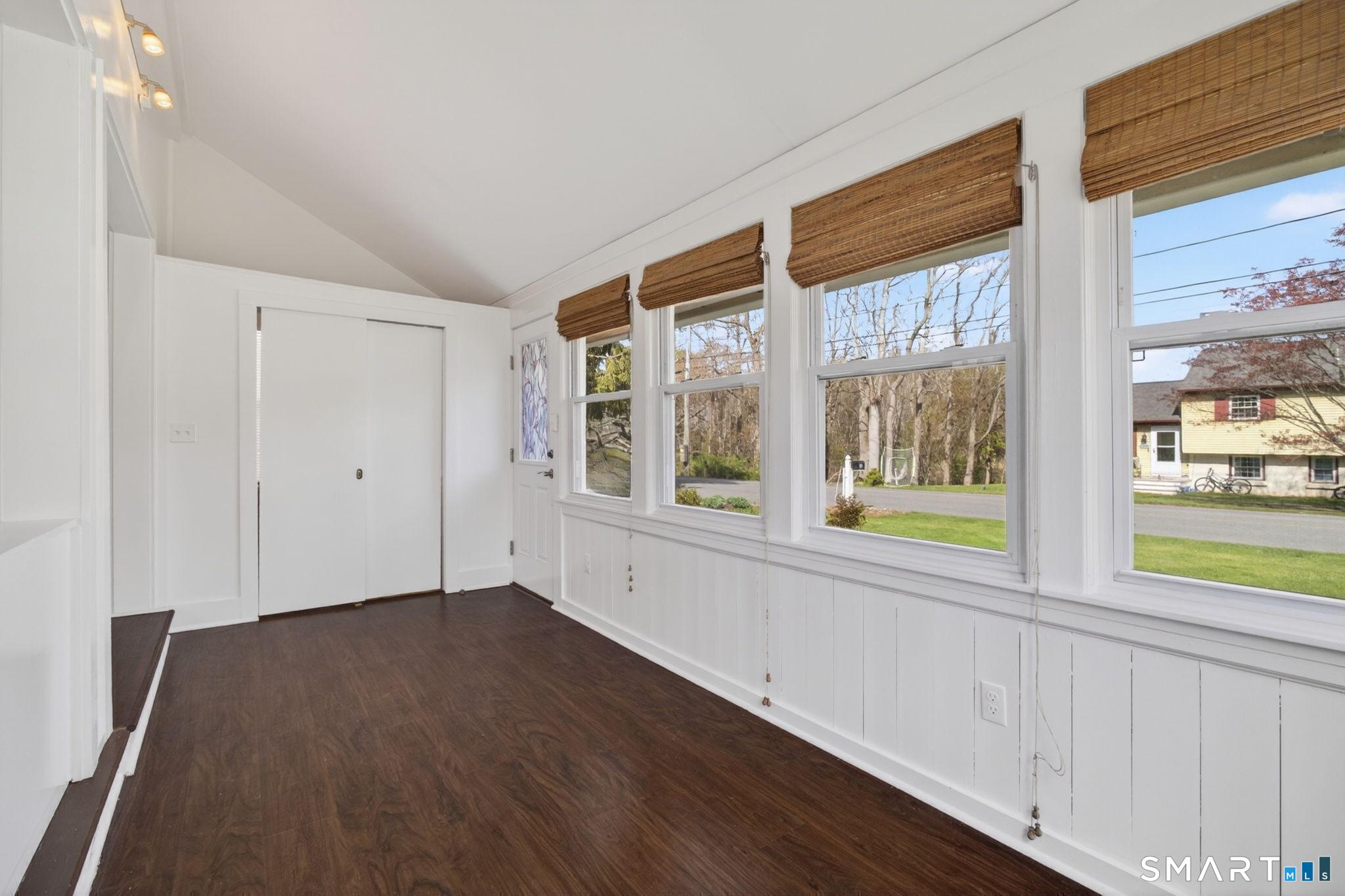 61 Ingham Hill Road Old Saybrook, CT 06475 - Photo 4 of 32 a view of an empty room with wooden floor and a window