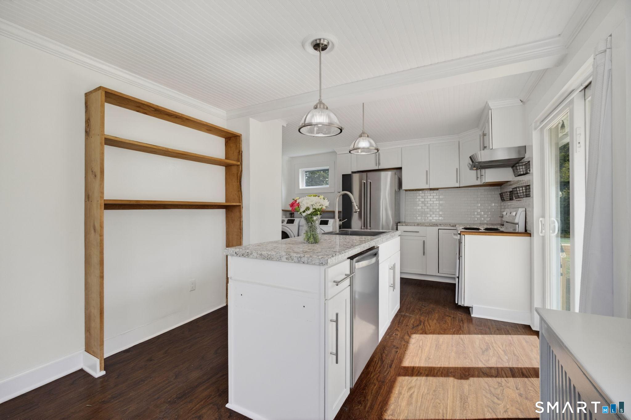 61 Ingham Hill Road Old Saybrook, CT 06475 - Photo 10 of 32 a kitchen with white cabinets and white appliances