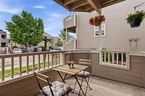 a backyard of a house with barbeque oven table and chairs