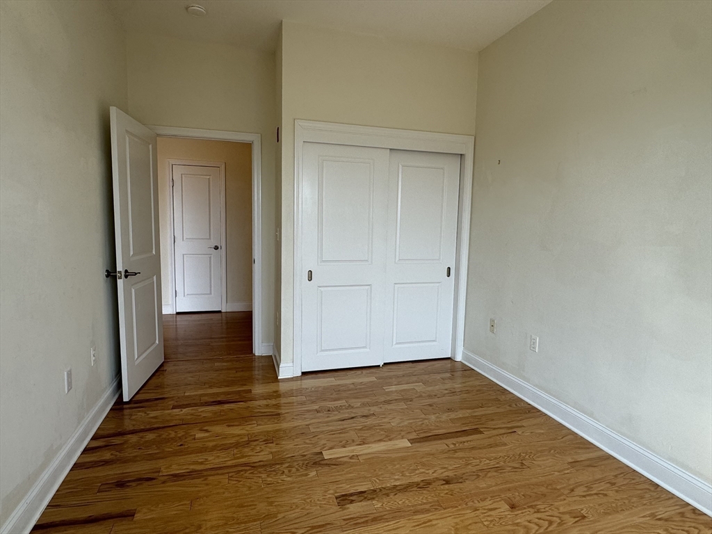 500 Union Street, Unit 5304 Westborough, MA 01581 - Photo 13 of 26 a view of an empty room with wooden floor