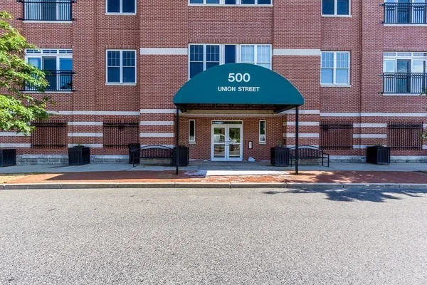 a view of a brick building with many windows