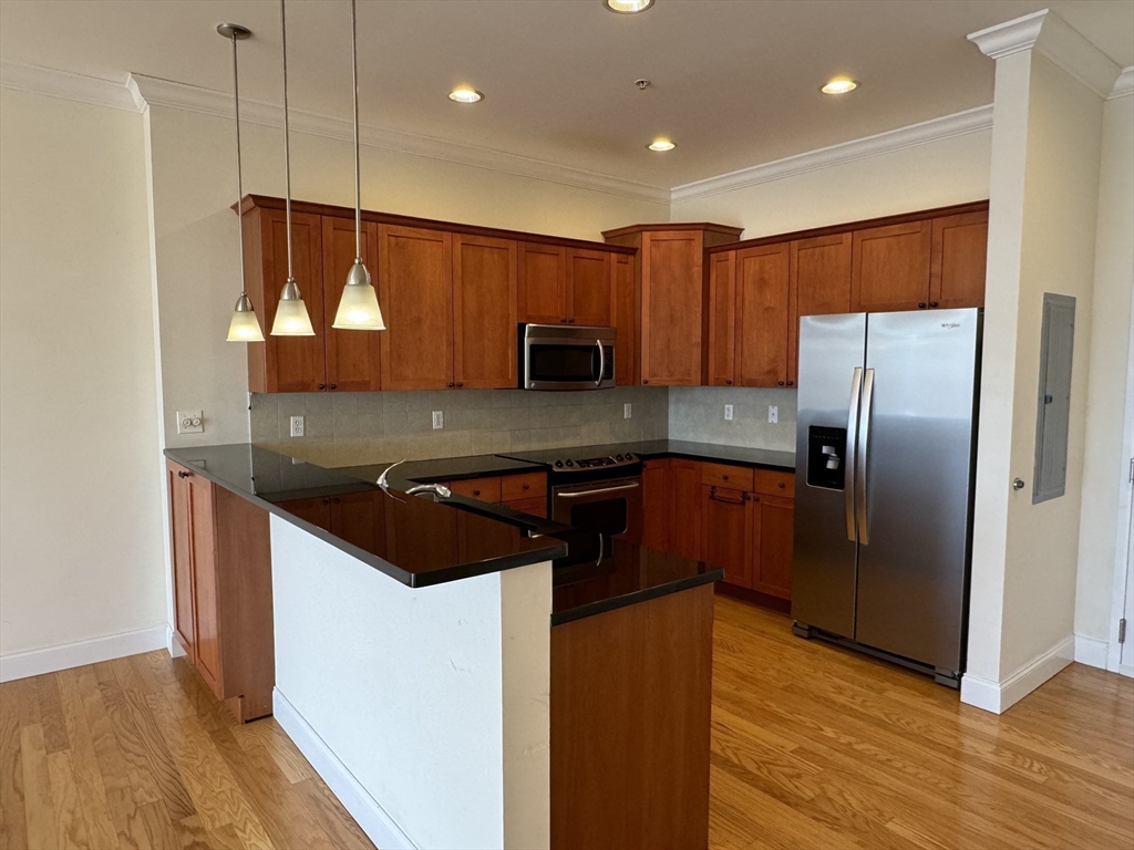 500 Union Street, Unit 5304 Westborough, MA 01581 - Photo 5 of 26 a kitchen with granite countertop stainless steel appliances and wooden cabinets