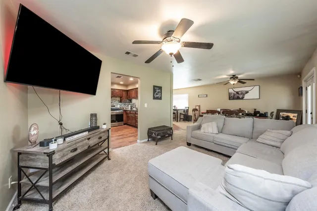 a living room with furniture and a flat screen tv