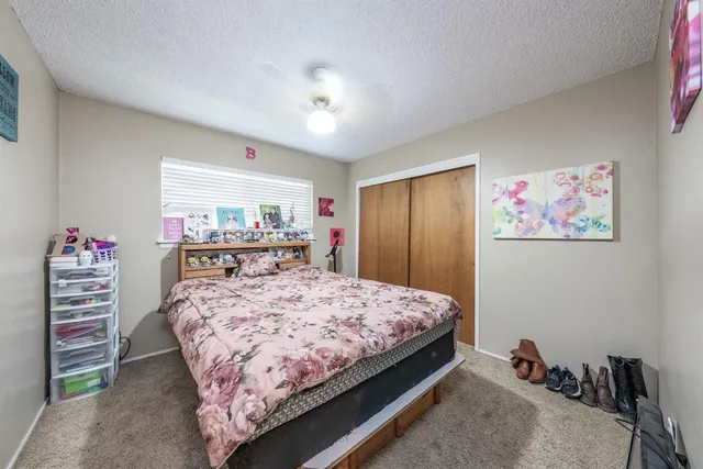 a bedroom with a bed and a dresser in it