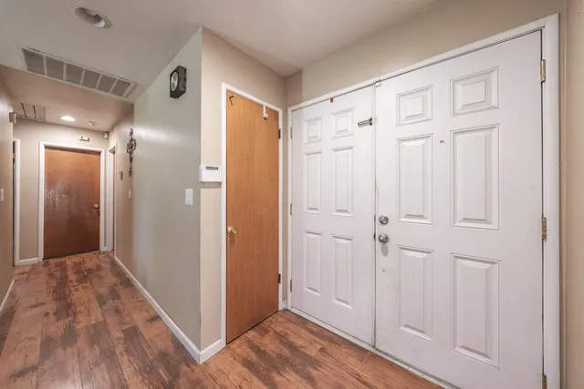 a view of a hallway with wooden floor